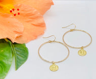 Gold hoop earrings with Om charm